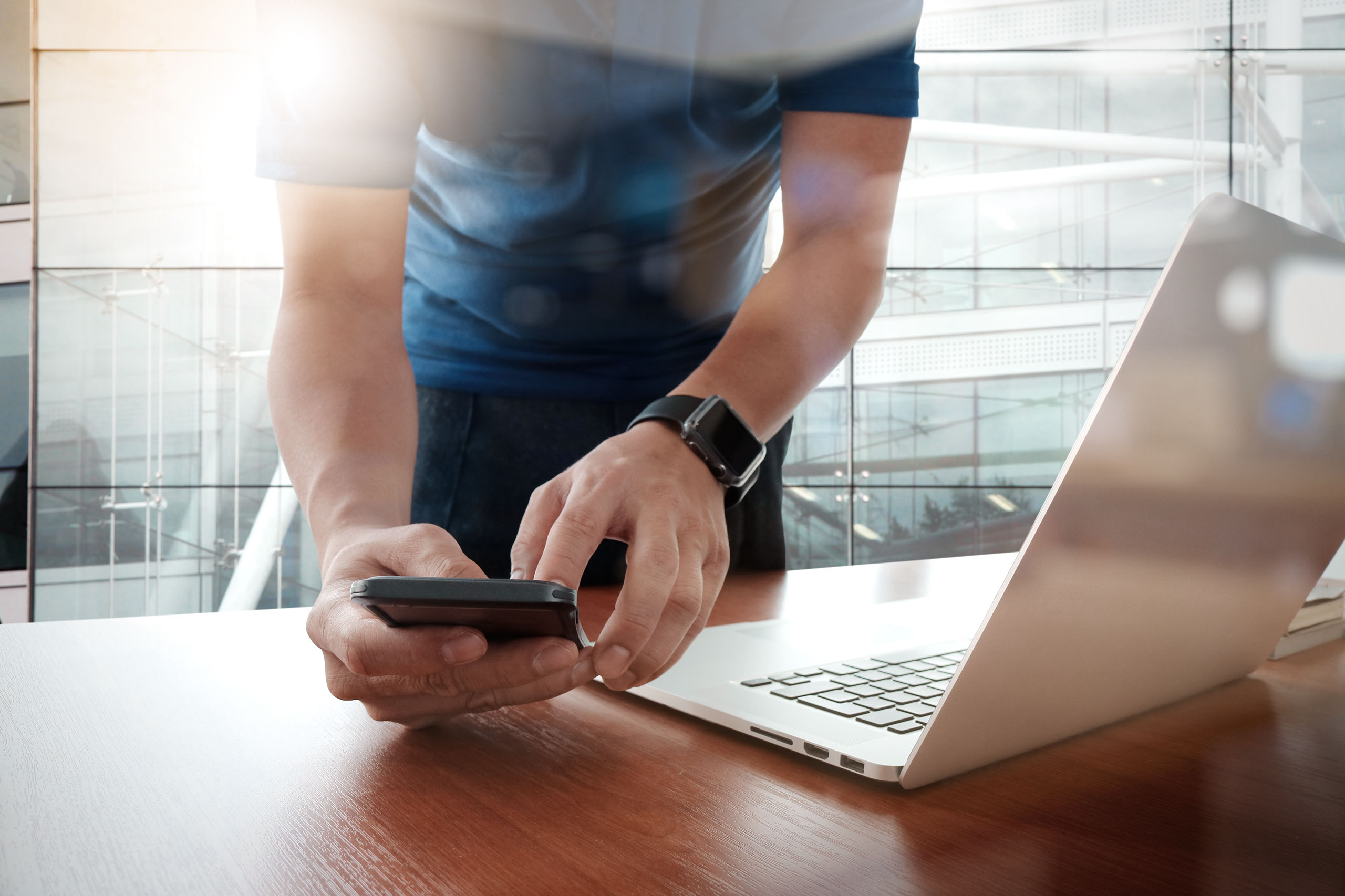 Home Page Slider - Business man with iPhone and MacBook
